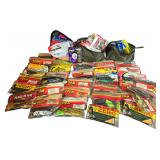 An Assortment of Bass Fishing Soft Plastic Lures, Stren Fishing Line, and Tackle Pouches