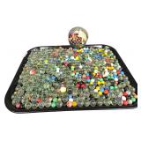 An Assortment of Vintage Marbles with a Stenciled Apple Crate and Storage Container