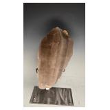 A LARGE SMOKEY QUARTZ CRYSTAL MOUNTED ON A STAND