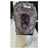 AN AMETHYST GEODE WITH POLISHED EDGES