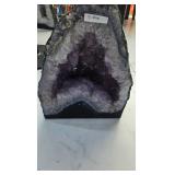 AN AMETHYST GEODE WITH POLISHED EDGES