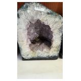 AN AMETHYST GEODE WITH POLISHED EDGES