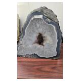 AN AMETHYST GEODE WITH POLISHED EDGES.