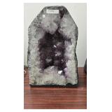 AN AMETHYST GEODE WITH POLISHED EDGES.