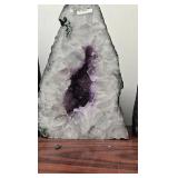 AN AMETHYST GEODE WITH POLISHED EDGES.