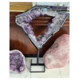 A LARGE AND WELL COLORED AMETHYST TRIANGLE SLICE ON A STAND