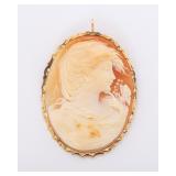 A LARGE HAND CARVED CAMEO IN A 14k FRAME