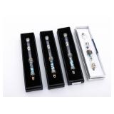A GROUP OF FOUR STERLING SILVER AND GLASS MEZUZOT. Israel, modern.