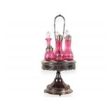 A Set of Five Victorian Cranberry Glass Bottles in an Ornate Silver-Plated Caster Stand