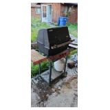 BBQ with new parts for repair (by garage)