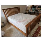 Queen sized bed including wood frame, mattress