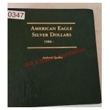9 American Eagle Silver Dollars in book