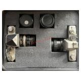 vintage film camera bodies and lenses in a fitted