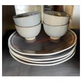 four plates four bowls lot (garage)