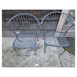 Pair of metal patio chairs- side of house