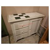 Tile topped cabinet with drawers and cupboard -