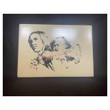 a woman carrying a baby in a traditional carrier