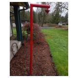 red-painted metal yard stake for bird feeder