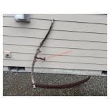 Antique Scythe used as outdoor yard decor