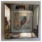 decorative wall mirror with a bird-themed art