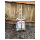 Hoe and Bag of Soil                         (Back