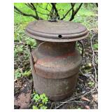 Vintage metal Milk Can used as yard art
