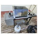 Weber grill with half full propane tank, rough