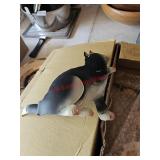 Tin kitties, left of the garage