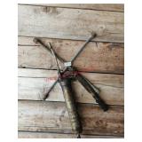 Lug wrench and grease gun- right of garage