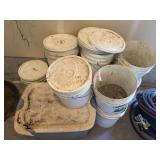 many Buckets half filled with manure