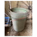 Empty garbage can   (Left side of barn Behind