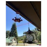 Two Bird Feeders on Front Porch