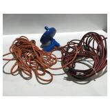 2 Electric extension cords, and a drain snake