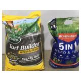 Two bags of weed and feed both have holes