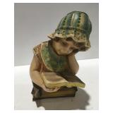 Chalkware girl reading book