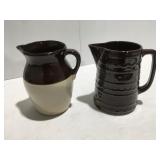 2 stoneware pitchers one cracked