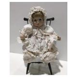 Doll baby in a chair