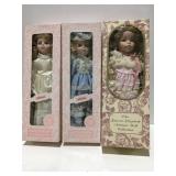Three dolls in boxes
