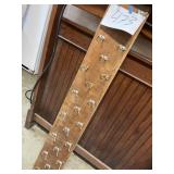 23 coat hooks mounted on 62 inch board