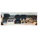 Collection of Glasses and Bow Ties With Cases