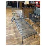 Reclining green metal chair