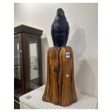 Carved wooden parrot on stand
