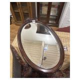 Oval shaped carved wood mirror