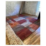 Large gray, red and orange area rug