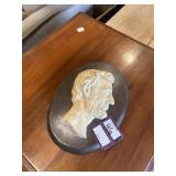 Metal Abraham Lincoln head mounted on wood