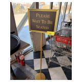 PLEASE WAIT TO BE SEATED SIGN