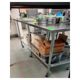 8 FOOT SS TABLE WITH UNDER SHELF AND ON CASTERS