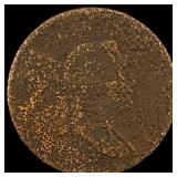 The coin is too corroded to accurately identify. H