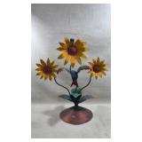 metal sculpture of three sunflowers with a