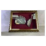 Two silver plated servers inside a frame